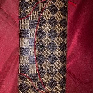 Louis Vuitton leather wallet with red trim